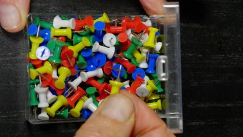 Hand choosing a push pin from a full box. Stock Footage 225481088