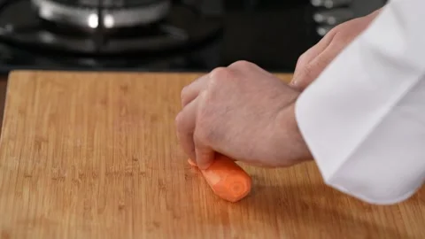Hand chopping carrots close-up Stock Footage 183507393