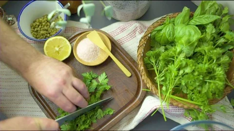 Hand chopping herbs in the kitchen Video stock 76133216