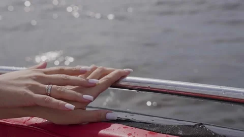 Hand on the chrome railing of a motorboat Stock Footage 329248792