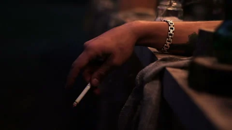 Hand with a cigarette on a dark background Stock Footage 52758188
