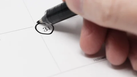 A hand circles 31st of October with a pen on a calendar. Stock Footage 117627751