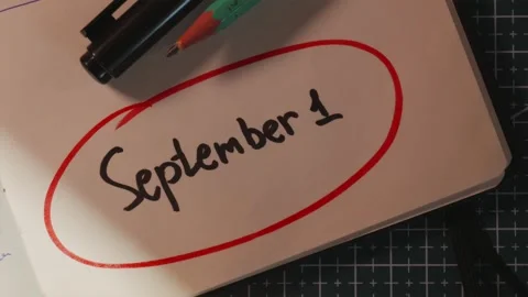 Hand circling 1 September date with red marker on paper Stock Footage 340139144
