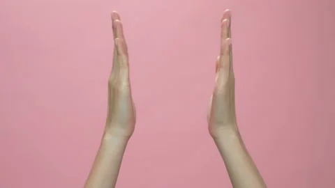 Hand clapping on the pink background. celebration concept. 스톡 동영상 153963716