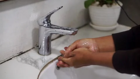 Hand cleaning activity with soap and clean water at a household Video stock 336663013