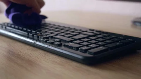Hand cleaning antiseptic from keyboard using microfiber cloth Stock Footage 131431469