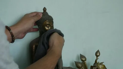 Hand Cleaning Buddha Statue with Black Cloth Stock Footage 325790102