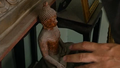 Hand Cleaning Buddha Statue with Black Cloth Stock Footage 327435103