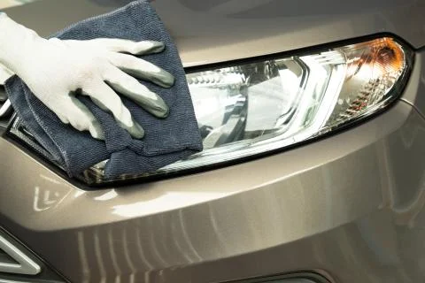 Hand cleaning car with blue micro-fiber cloth. Stock Photos