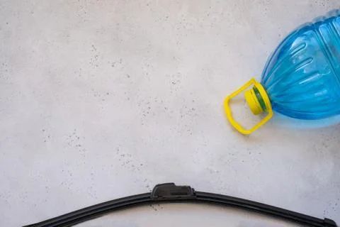 Hand cleaning a car windshield with window cleaner wiper. Stock Photos