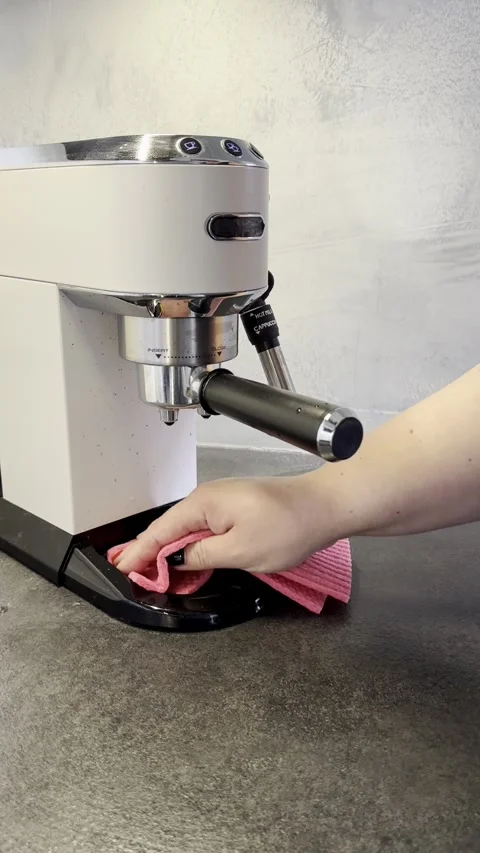 Hand Cleaning an Espresso Machine Drip Tray with a Pink Cloth Stock Footage 340138199