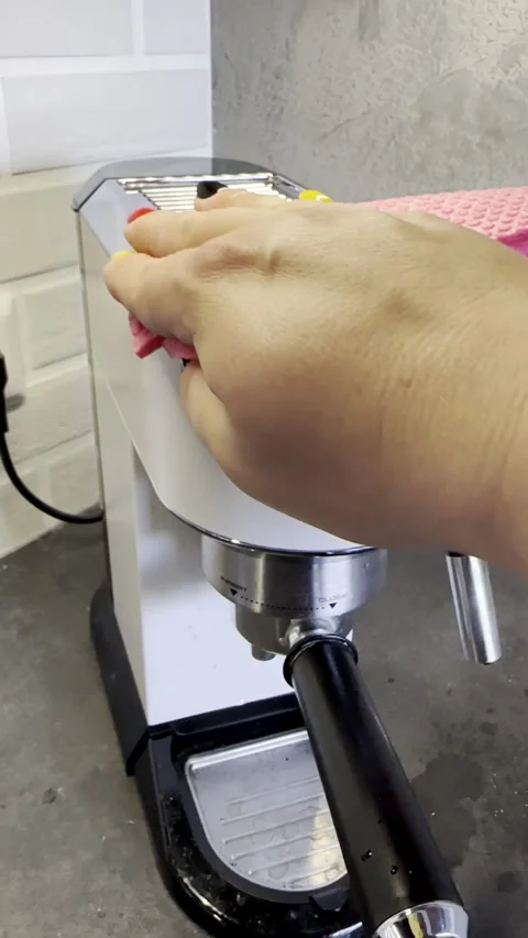 Hand Cleaning an Espresso Machine with a Pink Cloth Stock Footage 340138193