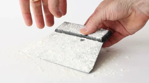 Hand cleaning off flour from bread dough scraper Stock Footage 196000294