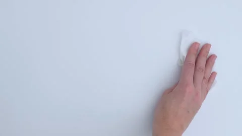 Hand cleaning a smooth surface with a cloth, showcasing a continuous motion Stock Footage 325530330