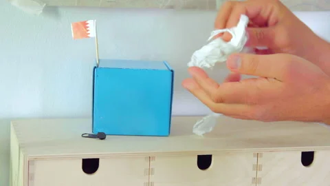 Hand cleaning tiny Bahrain flags with tissue Video stock 153227825