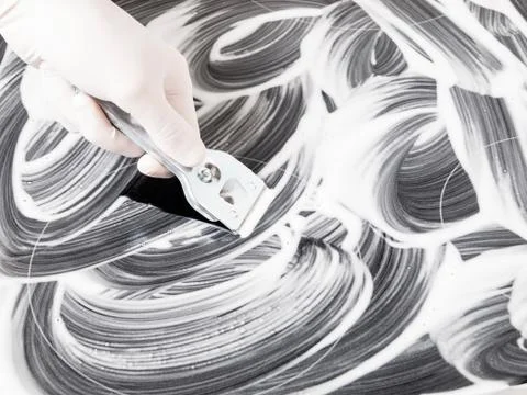 Hand cleaning a vitroceramic with a scraper Stock Photos
