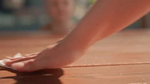 Hand Cleaning Wooden Surface with Cloth with table polishing texture brown Stock Footage 345968400
