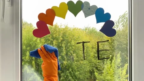 Hand cleaning word hate under rainbow make from hearts. Stock Footage 160670418