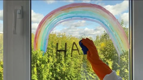 Hand cleaning word Hate under rainbow. Stock Footage 161457570