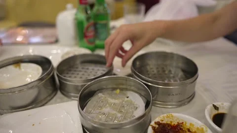 Hand cleans up empty dim sum steamer baskets Stock Footage 156872456