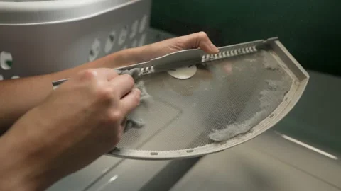 Hand cleans lint filter Stock Footage 156222556