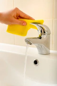 Hand cleans tap Stock Photos