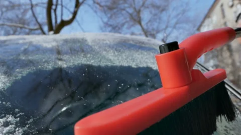 The hand cleans the windshield of the car from snow. In winter, the car was Stock Footage 150234845