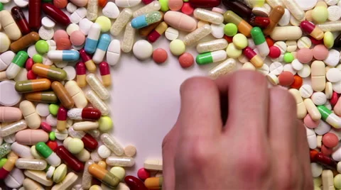 Hand clearing space in stack of pills Stock Footage 6775590