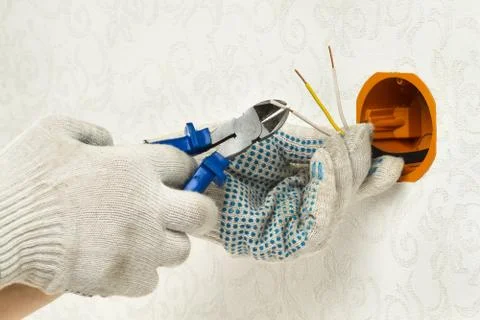 The hand clears the insulation of wires Stock Photos