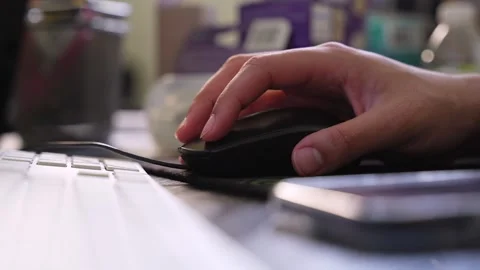 Hand clicking black computer mouse on desk Stock Footage 334091692