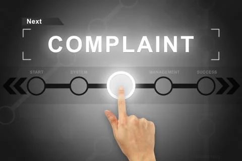 Hand clicking complaint button on a screen interface Foto stock