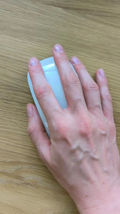 Hand clicking computer mouse on wooden desk. Top view of fingers navigating.. Stock Footage 344050463