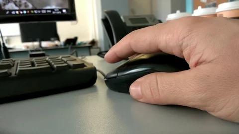 Hand clicking computer mouse. work table and coffee in office Video stock 99078561