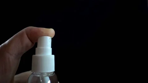 A hand clicks on a spray bottle in slow motion Vídeo Stock 132249101