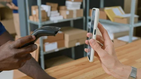 Hand of Client Demonstrating Code on Smartphone to Courier Service Employee Stock Footage 321436535