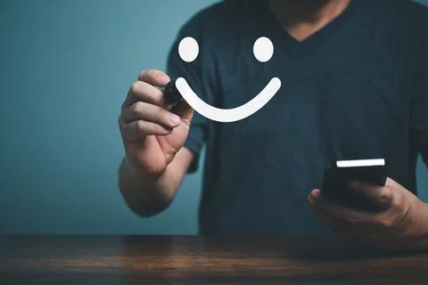Hand of client show a feedback with satisfaction smiling face sign and holdin Stock Photos