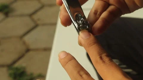 Hand Clipping Fingernails with Nail Clipper Stock Footage 346393338