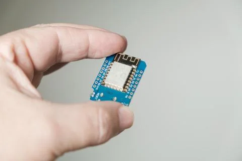 In hand, close-up of the ESP development board Stock Photos