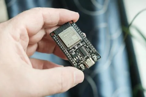 In hand, close-up of the ESP development board Foto stock