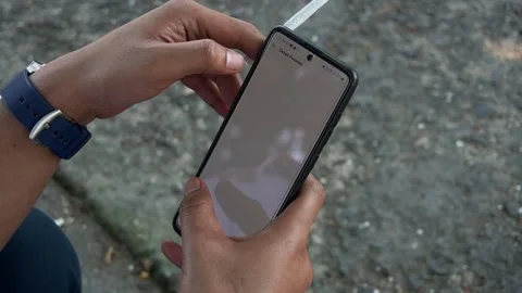 Hand closed up holding and operating the hand phone Video stock 201128665