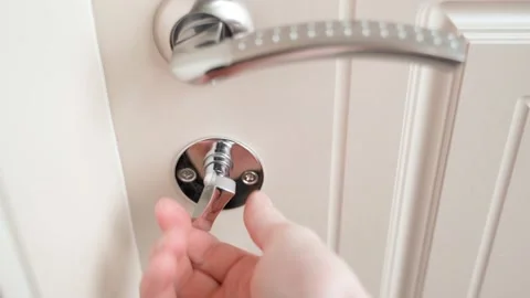 The hand closes the door and locks it. And checks if the door is closed. Closing Stock Footage 176709936