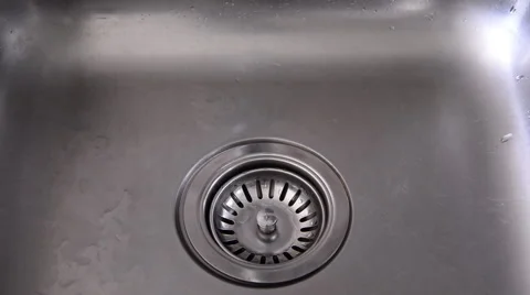 Hand closes the drain stopper from sink and water faucet running. Stock Footage 52458905