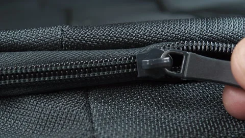 Hand closes zipper lock close-up of green textile backpack Stock Footage 152144343