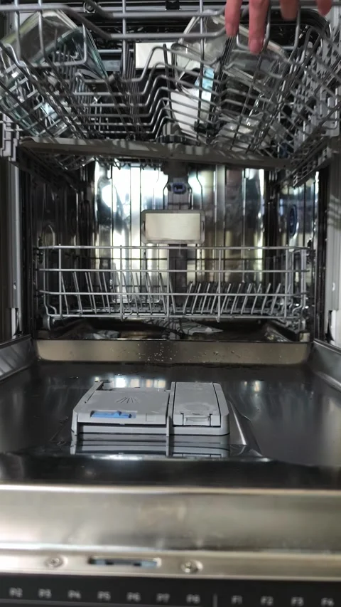 Hand closing lower dishwasher rack while upper basket opens for unloading. .. Stock Footage 344892036