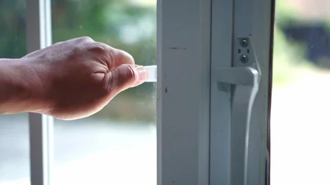 Hand closing a modern window handle in a bright home interior. Concept of home Stock Footage 340858403