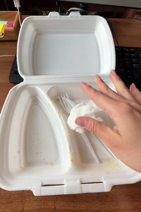 Hand closing a white styrofoam takeaway food container Stock Footage 335706662