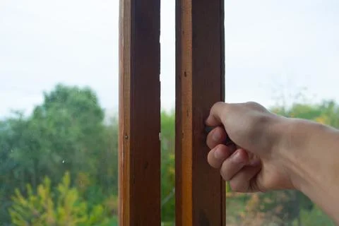Hand closing the window Stock Photos