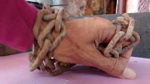 Hand clutching chain Stock Footage 262022708
