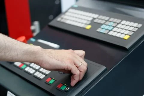 Hand of CNC machine operator on the control panel Stock Photos