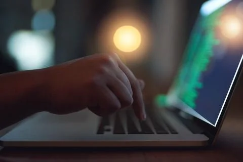 Hand, coding and hacker on laptop at night as malware thief for hacking database Stock-Fotos